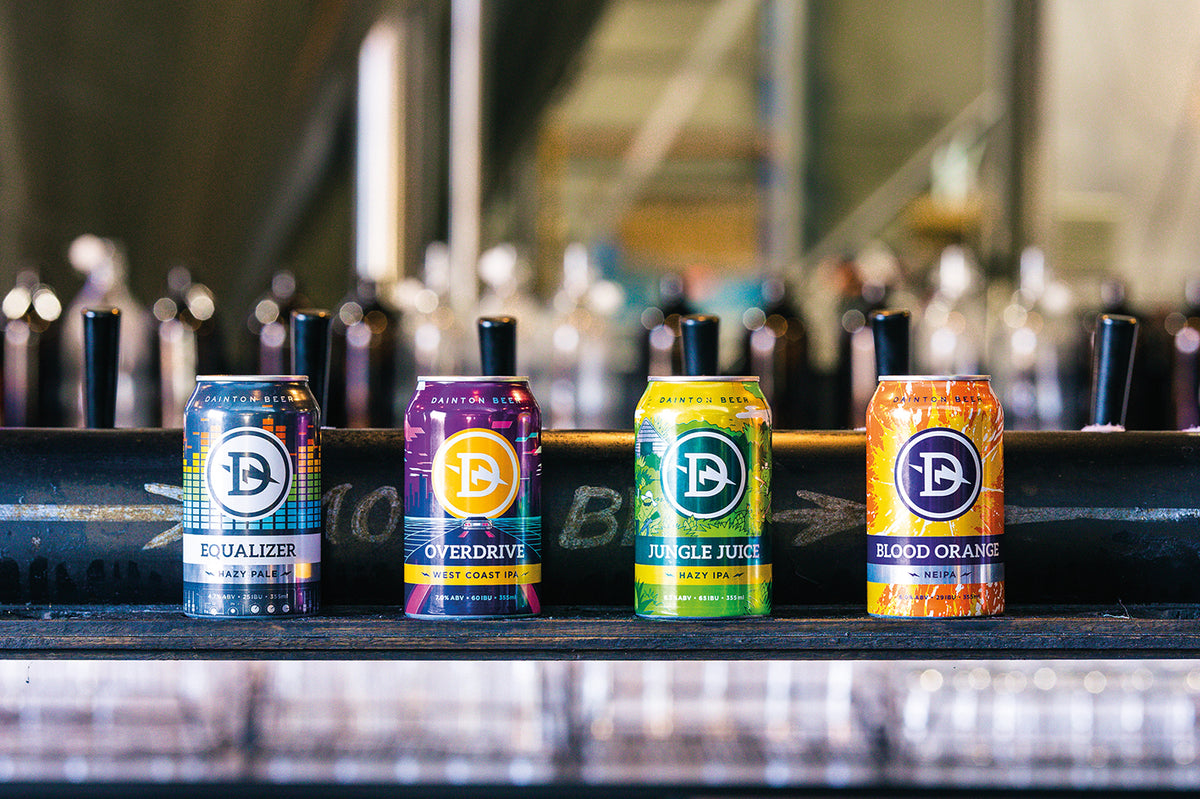 Equalizer, Overdrive, Jungle Juice and Blood Orange cans lined up on the taphouse bar